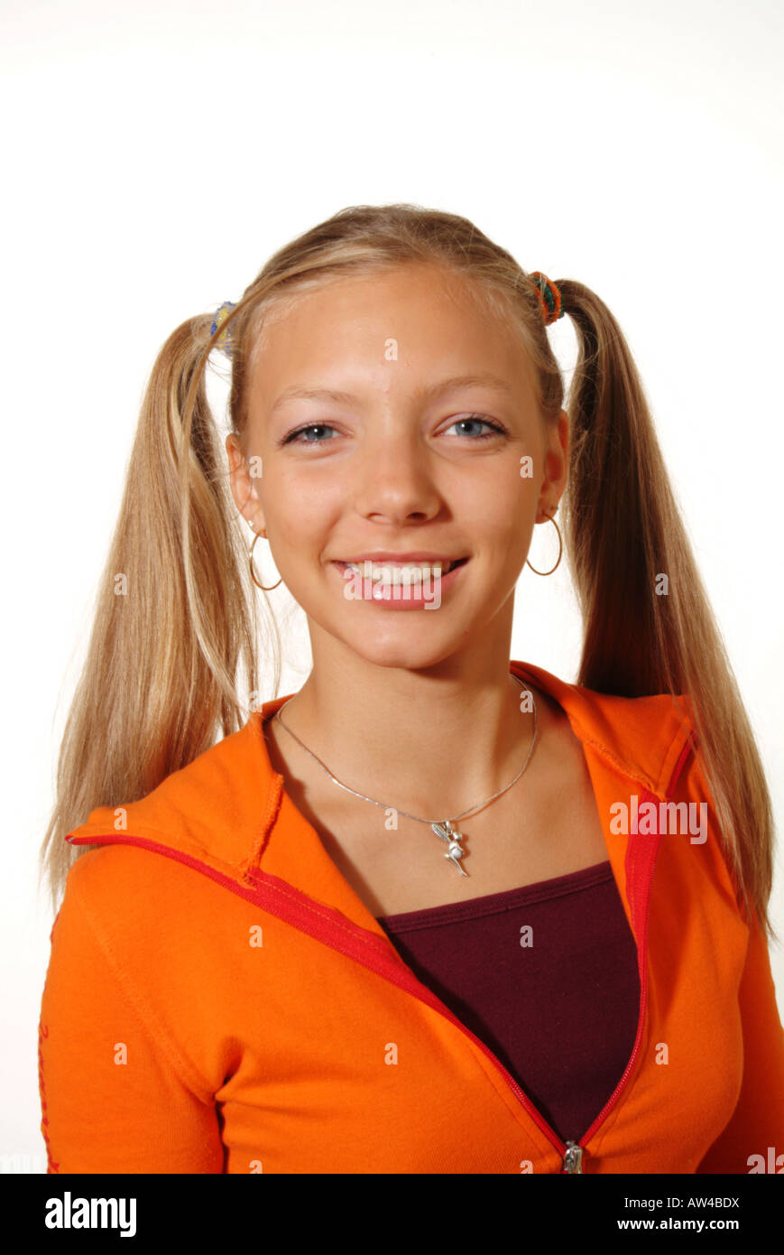 Laughing teenager with braids and orange jumper. Young woman. Girl. Stock Photo