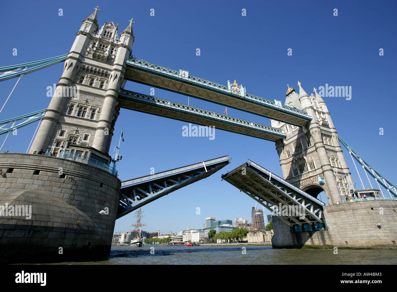 Tower Bridge opens  in London UK against blue sky Stock Photo