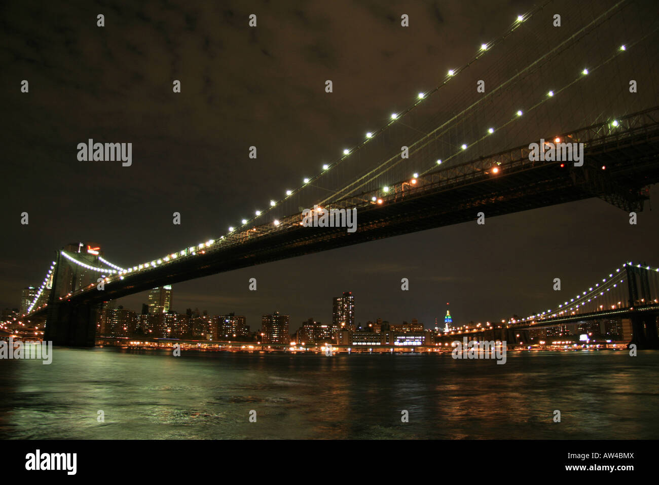 A night view in black and white of the Brooklyn Bridge, New York from below Franklyn D. Roosevelt Drive, Manhattan. Stock Photo
