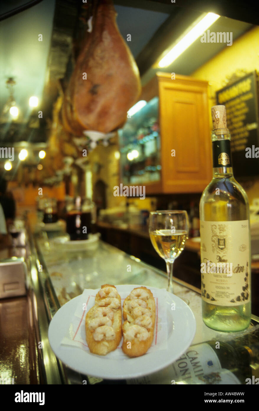 Toasted bread with prawns and Rueda white wine in La Tasquita Bar VALLADOLID Castile Leon region SPAIN Stock Photo