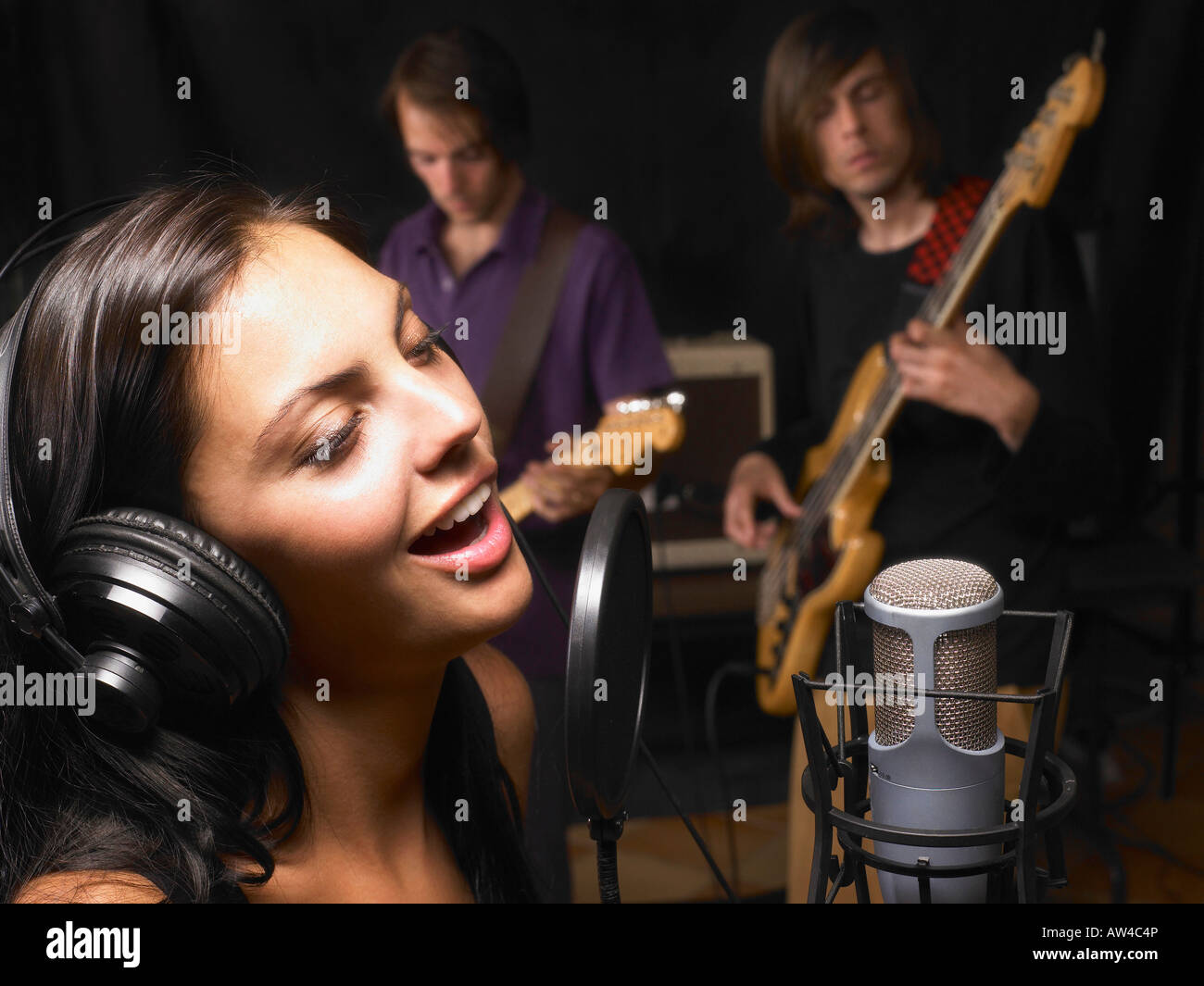 Woman singing in a band. Stock Photo