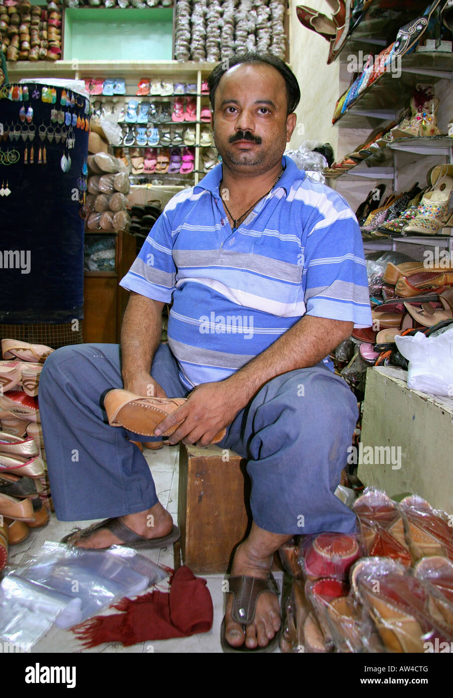 salesman inside a footwear shop delhi india Stock Photo