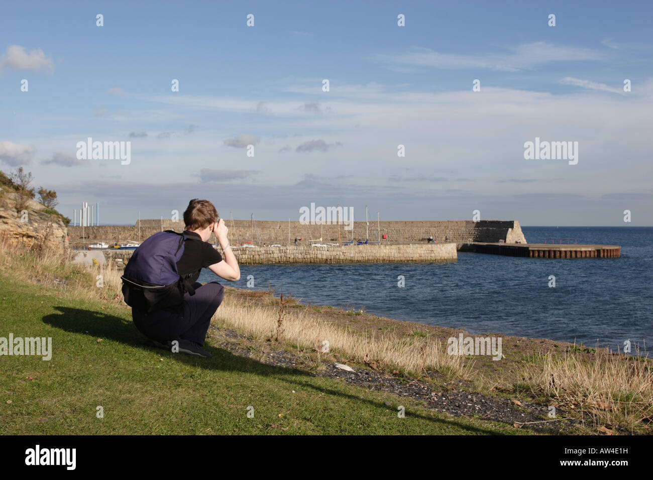 A walker on the Fife Coastal Path stops to take a photograph of Dysart