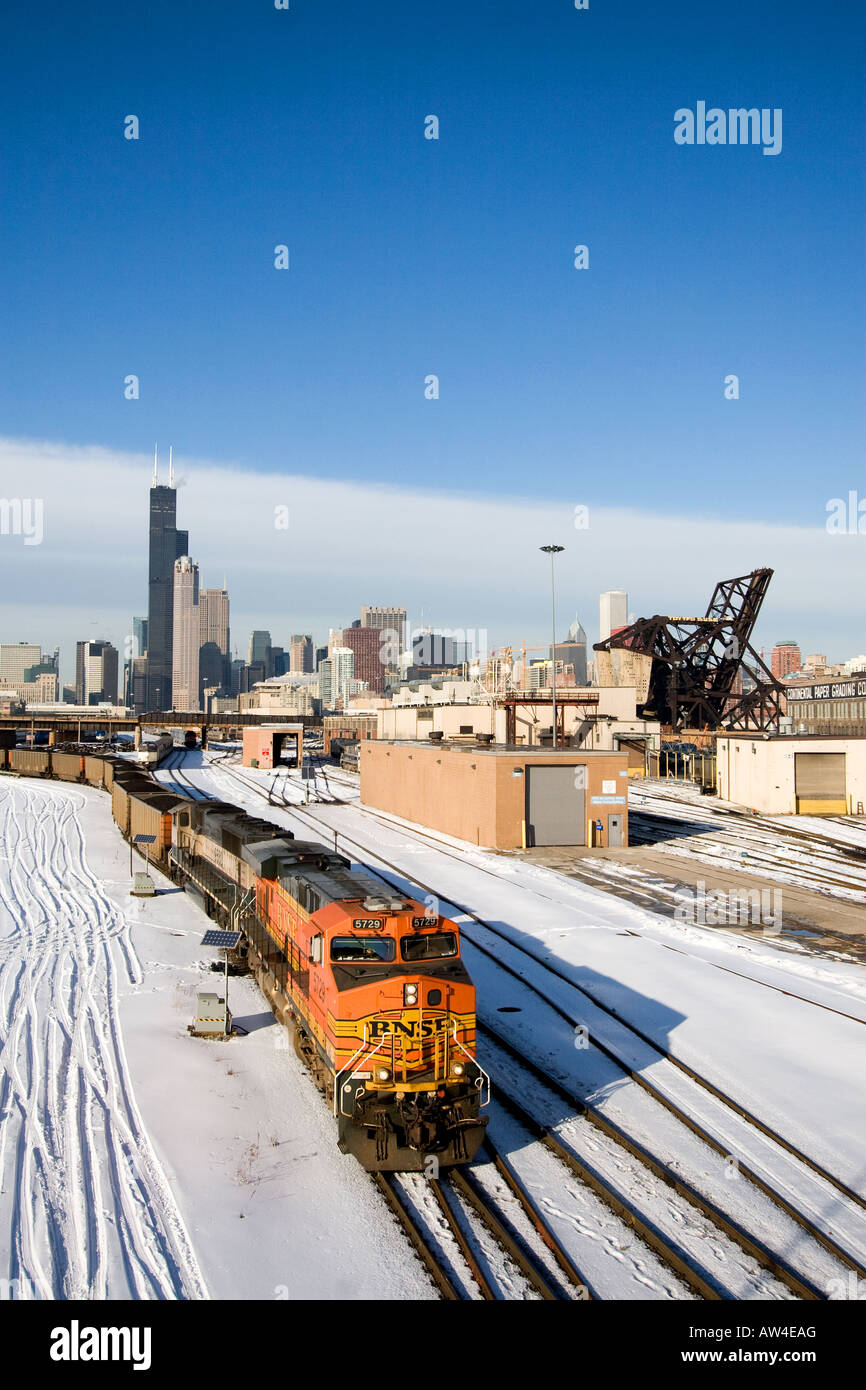 A BNSF coal train heads east under the skyline of Chicago. Stock Photo
