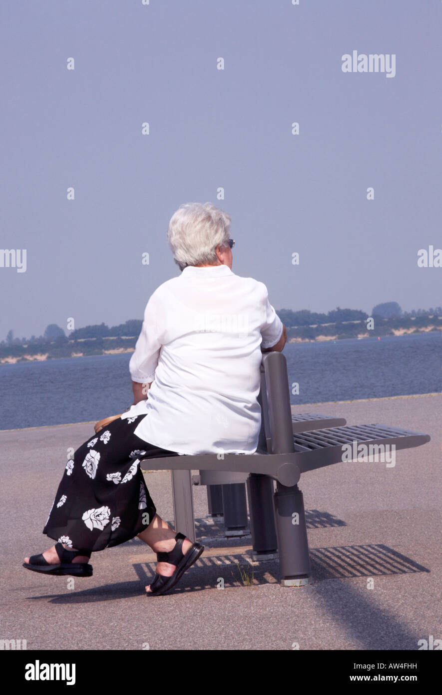 Mature woman thinking sitting bench hi-res stock photography and images ...
