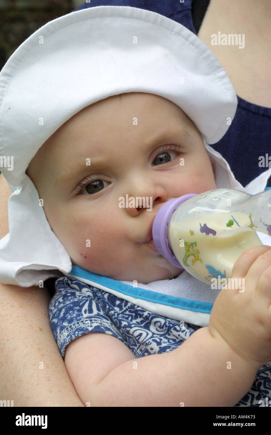 Nine month old baby boy drinking milk from a bottle Stock Photo Alamy