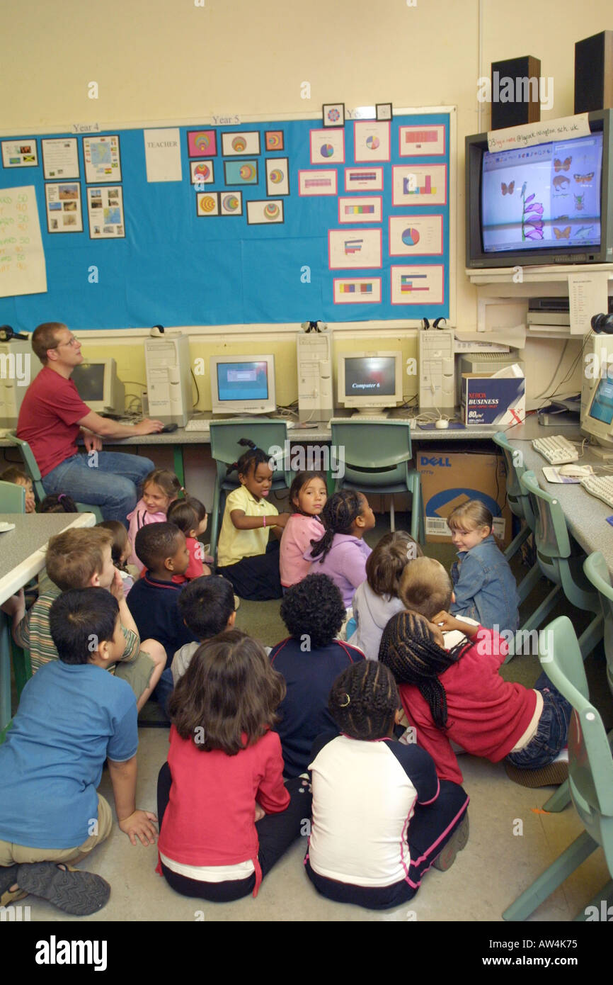 primary school teacher watching a video with his students Stock Photo