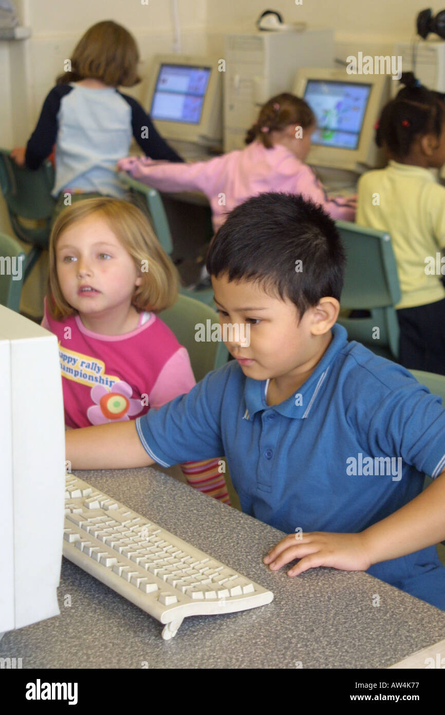 primary children working on computers in a classroom Stock Photo Alamy