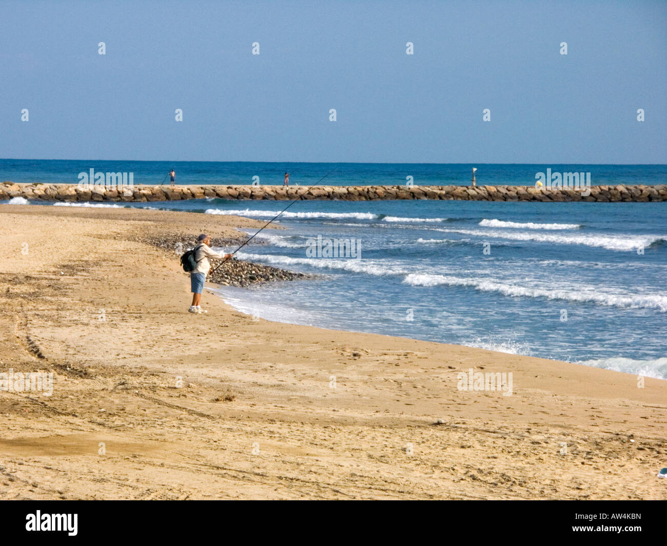 man-fishing-on-the-beach-at-cambrils-costa-dorada-catalonia-spain