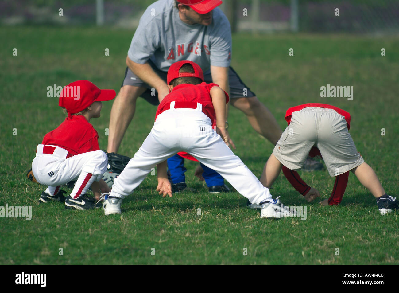 little baseball players stretching Stock Photo