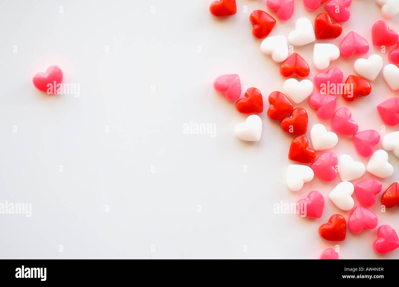 One candy heart separated from the others Stock Photo