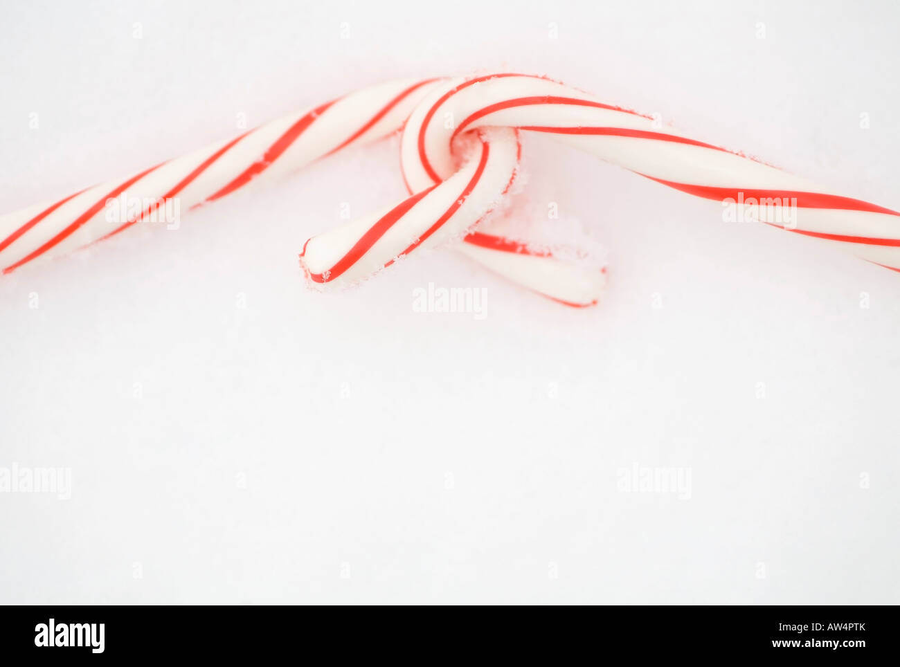 Two candy canes in the snow Stock Photo
