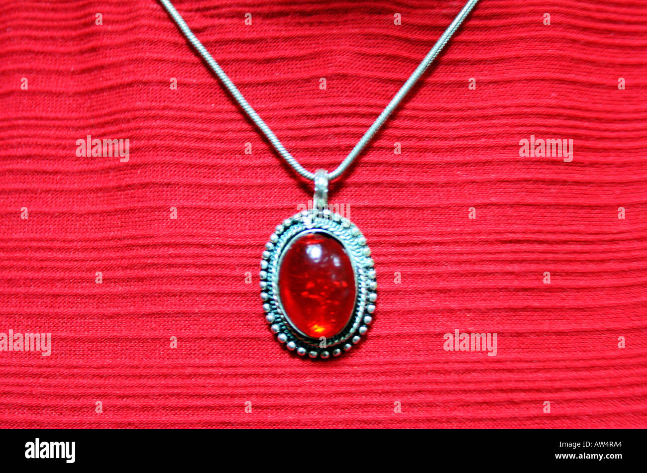 Red pendant on a chain Stock Photo