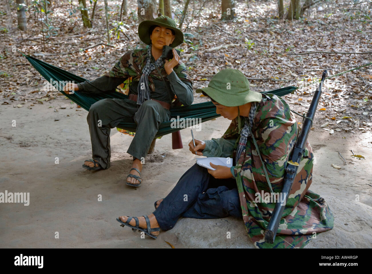 Mannequins of two VIET CONG soliders sit in hammocks in the CU CHI