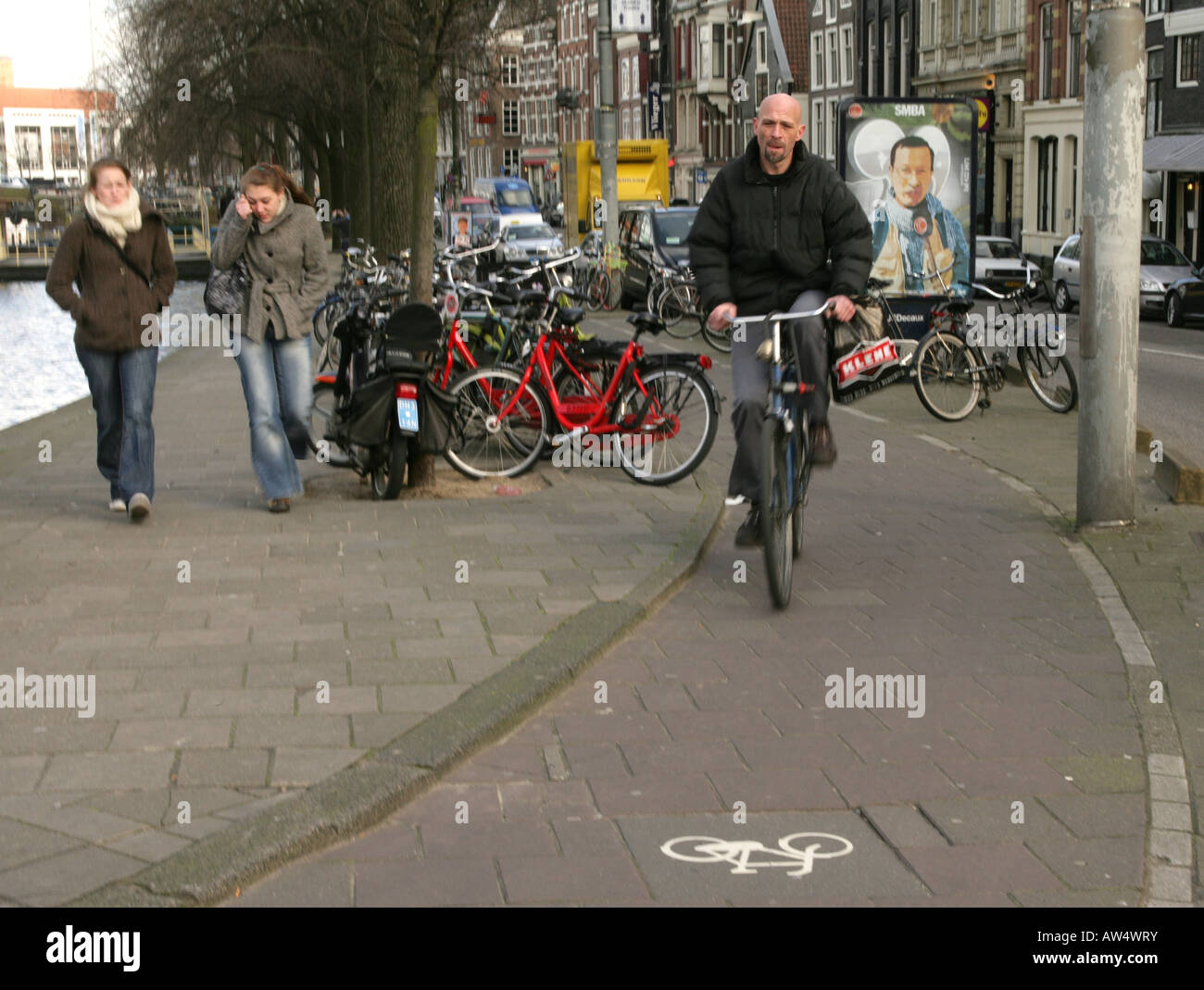A cyclist riding on a dedicated cycle lane in Amsterdam - one of the most bicycle-friendly cities in the world. Stock Photo