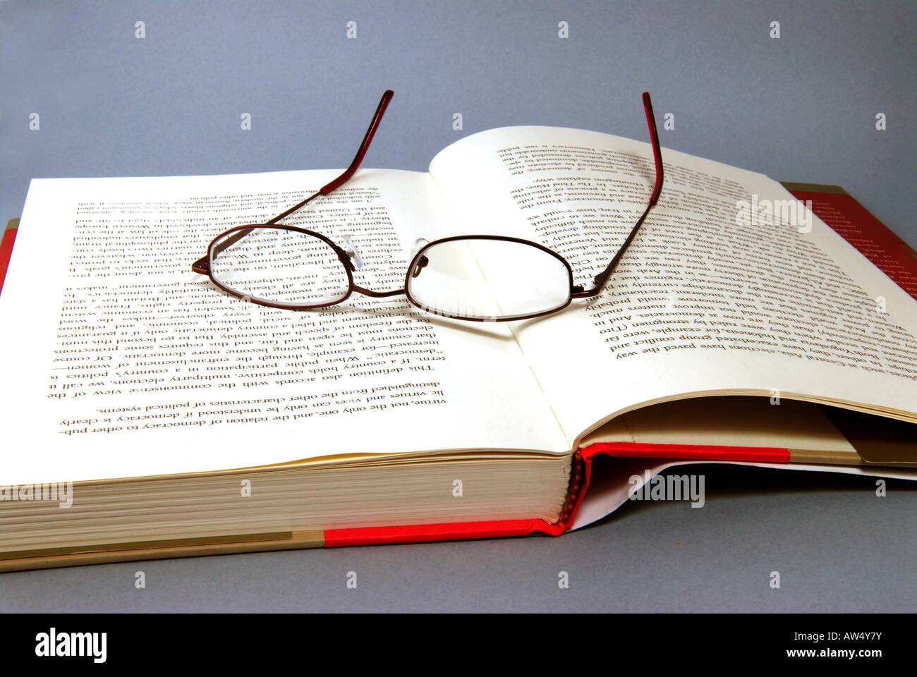 Open book with reading glasses Stock Photo