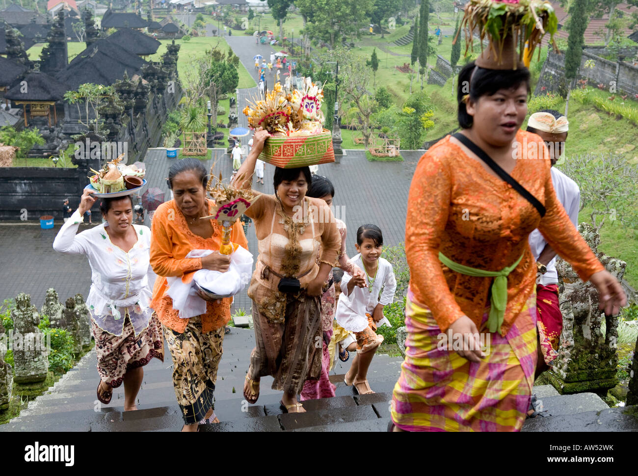 A Balinese Funeral Procession Carrying Umbrellas Votive Offerings  Climbing The Steps To The Pura Besakih Temple Bali Indonesia Stock Photo