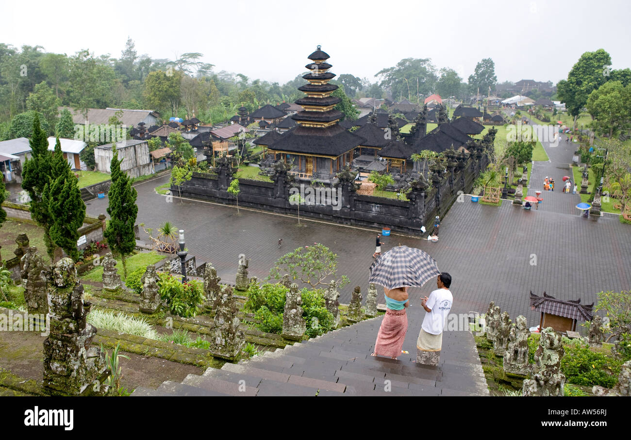 Tourists Carrying Umbrellas Climbing The Steps Up To The Pura Besakih Temple Bali Indonesia Stock Photo