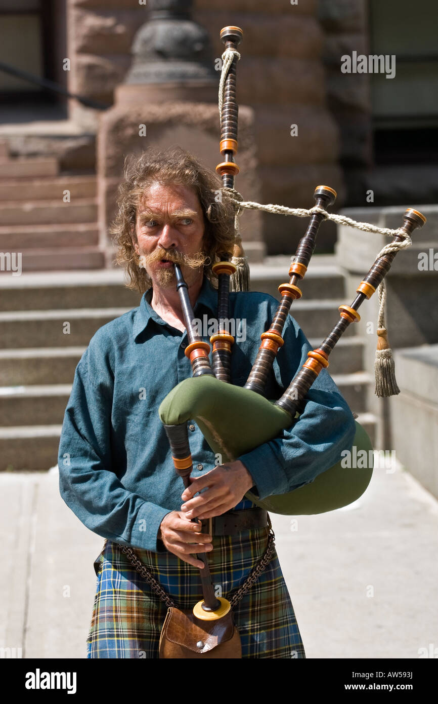 Man in traditional Scottish kilt playing bagpipes, Toronto, Canada Stock Photo