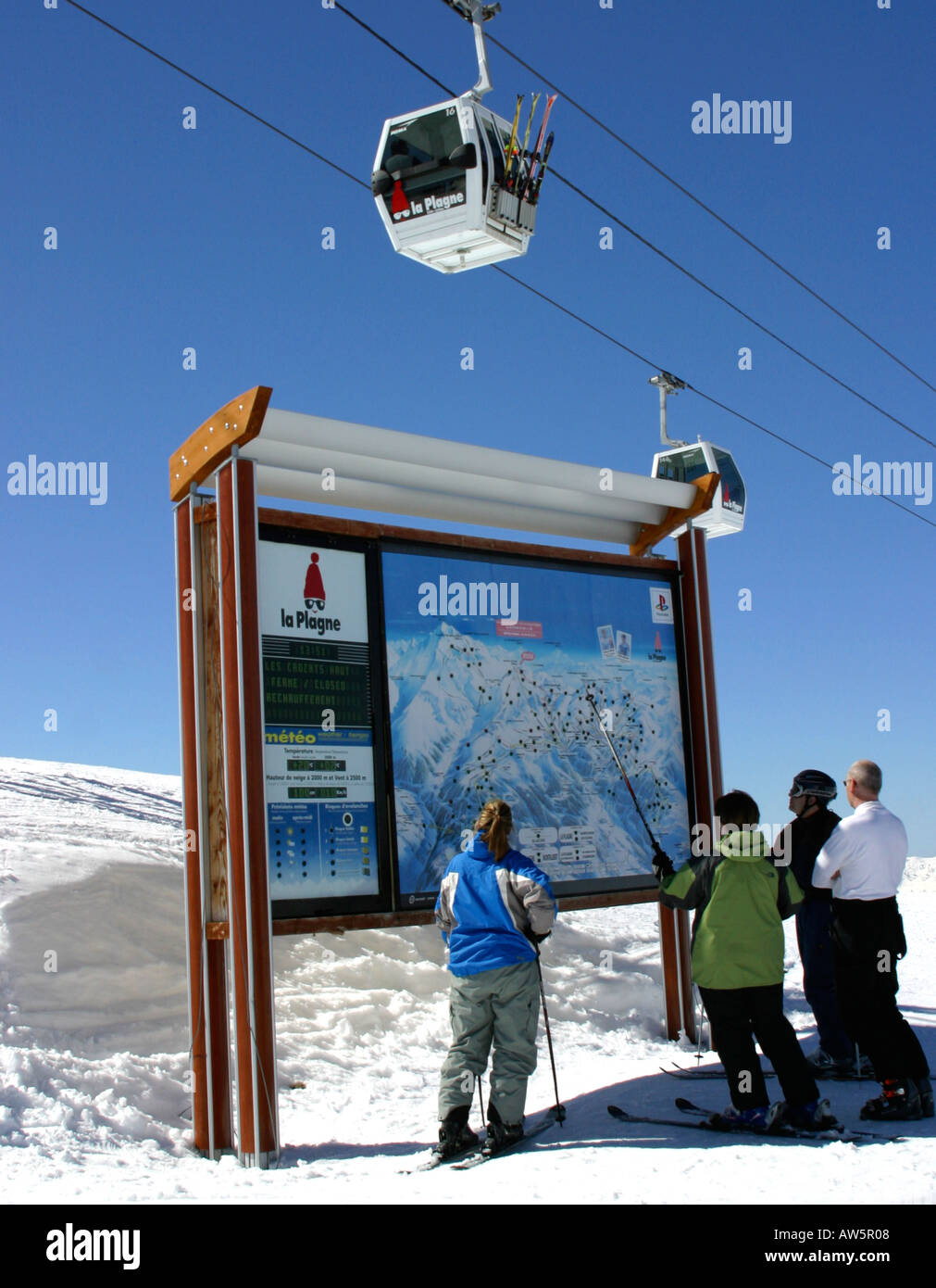 Skiers Checking The Piste Map At La Plagne France Stock