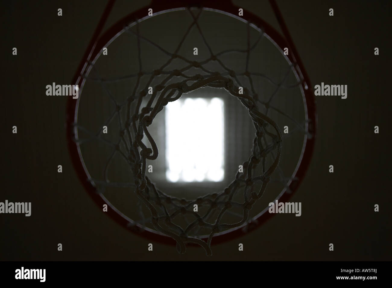 Looking Up Through Bottom Of Basketball Net Towards Ceiling Light