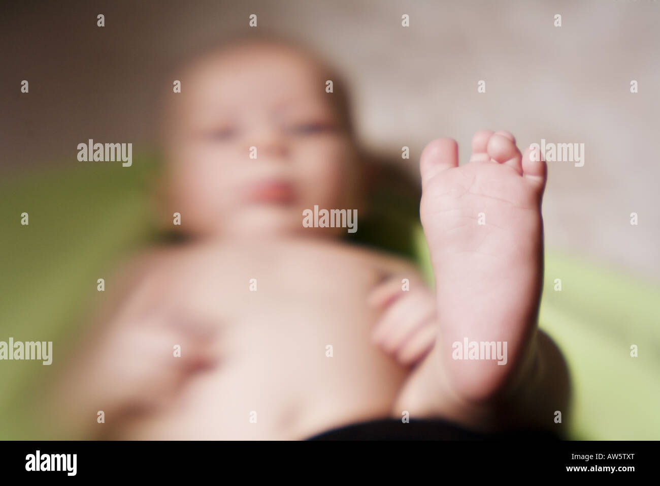 A silly baby discovers his feet for the first time Stock Photo Alamy