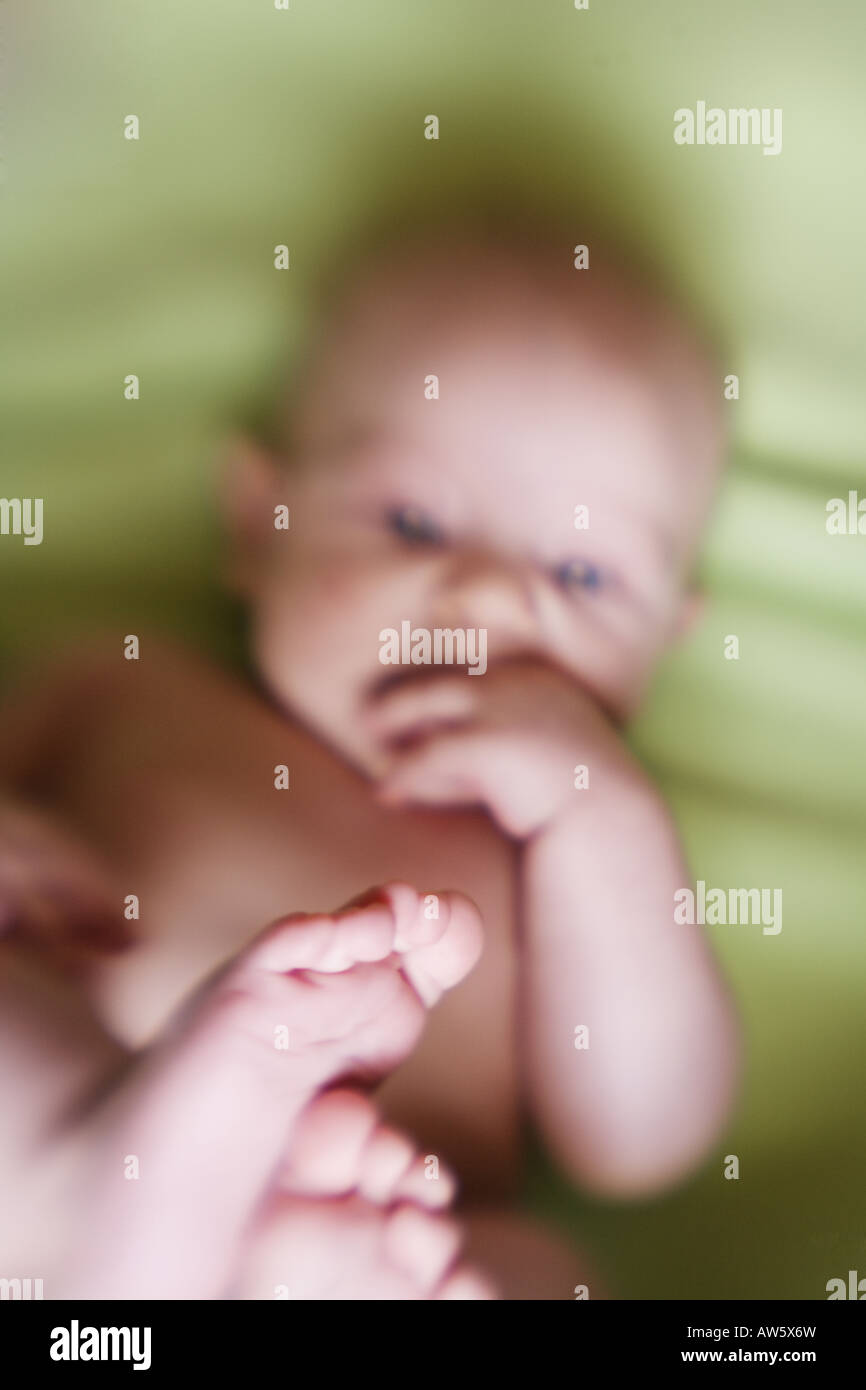 A silly baby discovers his feet for the first time Stock Photo Alamy