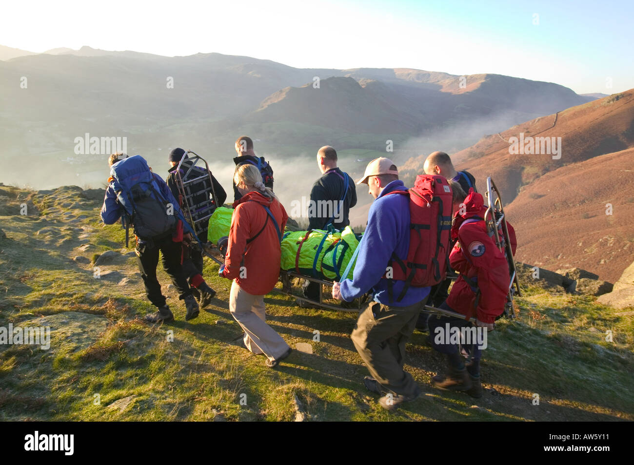 Walking Rescuers mountain rescue team members stretcher an injured walker off fairfield ...