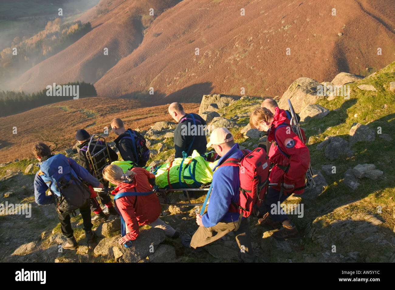Walking Rescuers mountain rescue team members stretcher an injured walker off fairfield ...
