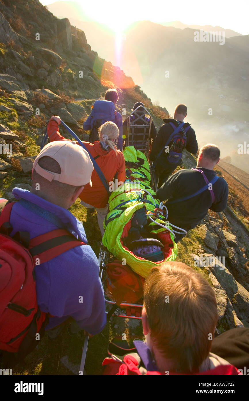 Walking Rescuers mountain rescue team members stretcher an injured walker off fairfield ...