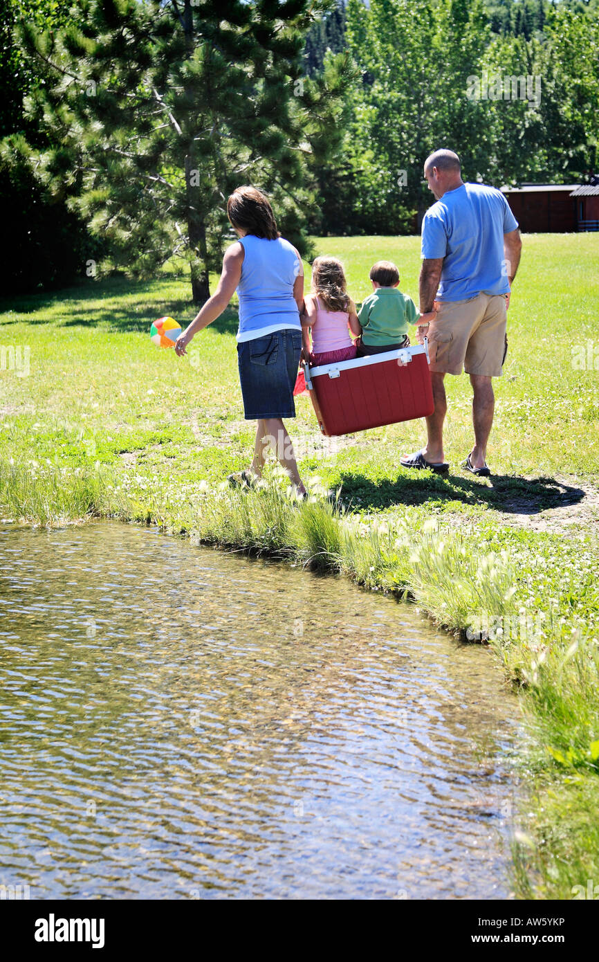 Family walking along water Stock Photo