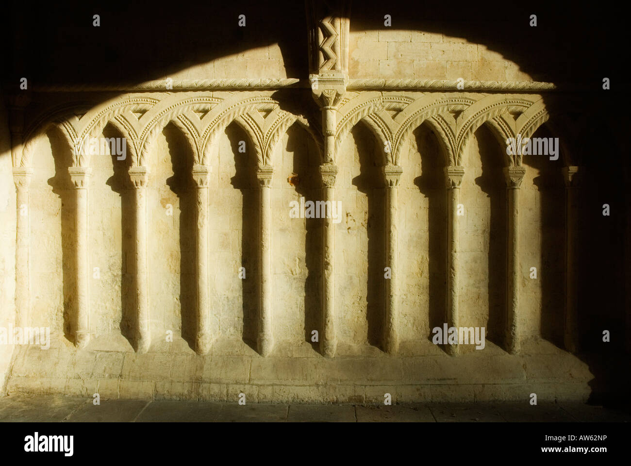 Sunlight falling on arches carved into an exterior wall at the Abbey Gatehouse Bristol Cathedral Stock Photo