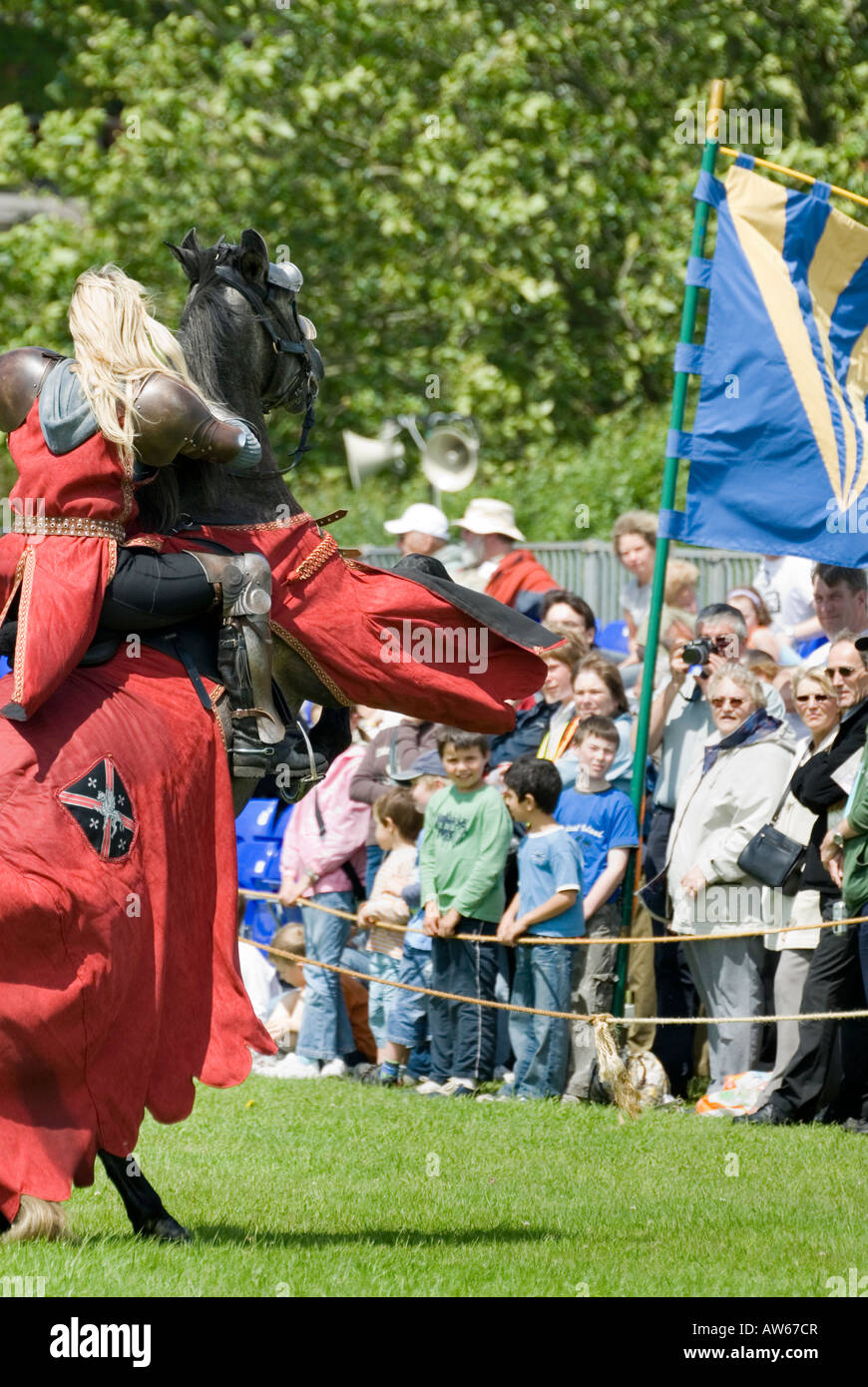 Red Dressed Female Knight on Rearing Horse Entertains Crowds at Tewkesbury Medieval Festival England 2007 NR Stock Photo