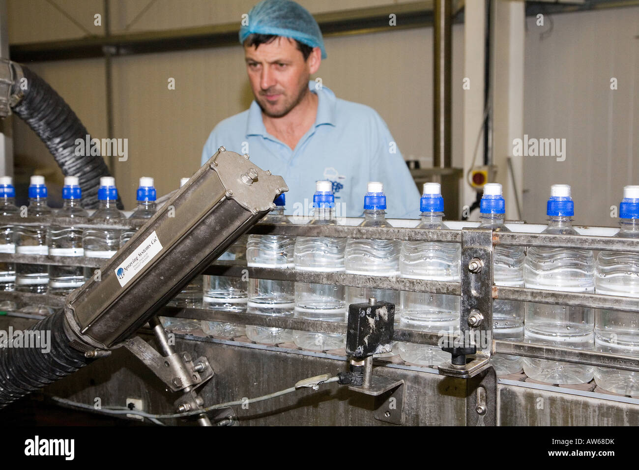 Plastic Water bottle still sparkling  labelling process line.  'Princess Gate' bottling plant, factory, Narberth, Pembrokeshire Stock Photo