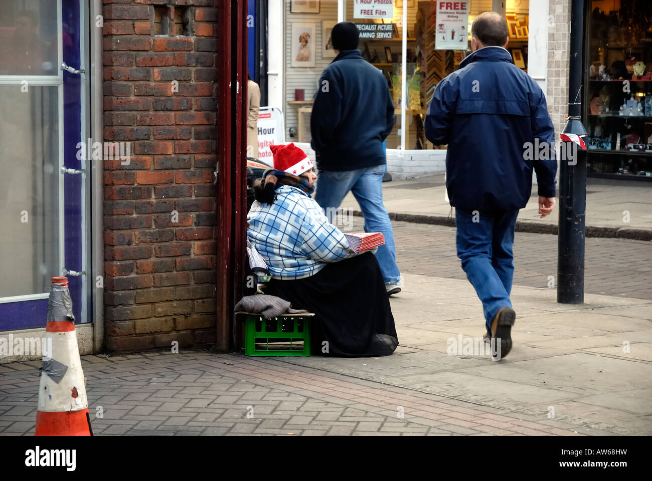 Man ignoring seller of 'Big Issue' at Christmas, Jackson Centre, Bishops Stortford, Hertfordshire Stock Photo