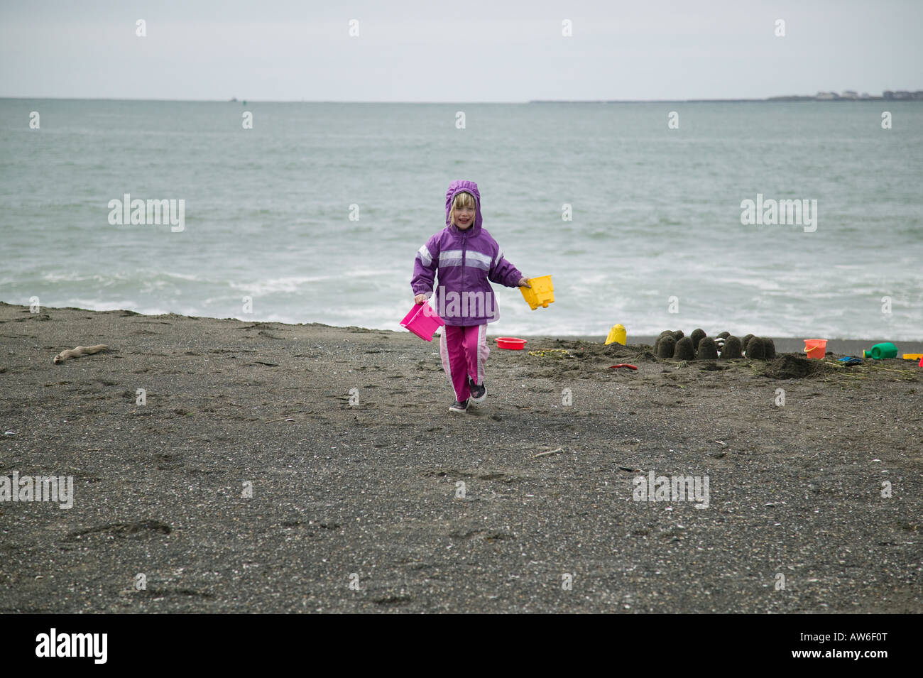 Girl playing on beach Grays Harbor, Washington, USA Stock Photo