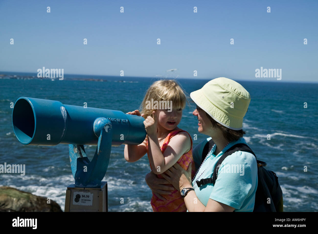 Mom and daughter and viewing scope Shore Acres State Park, Oregon, USA Stock Photo