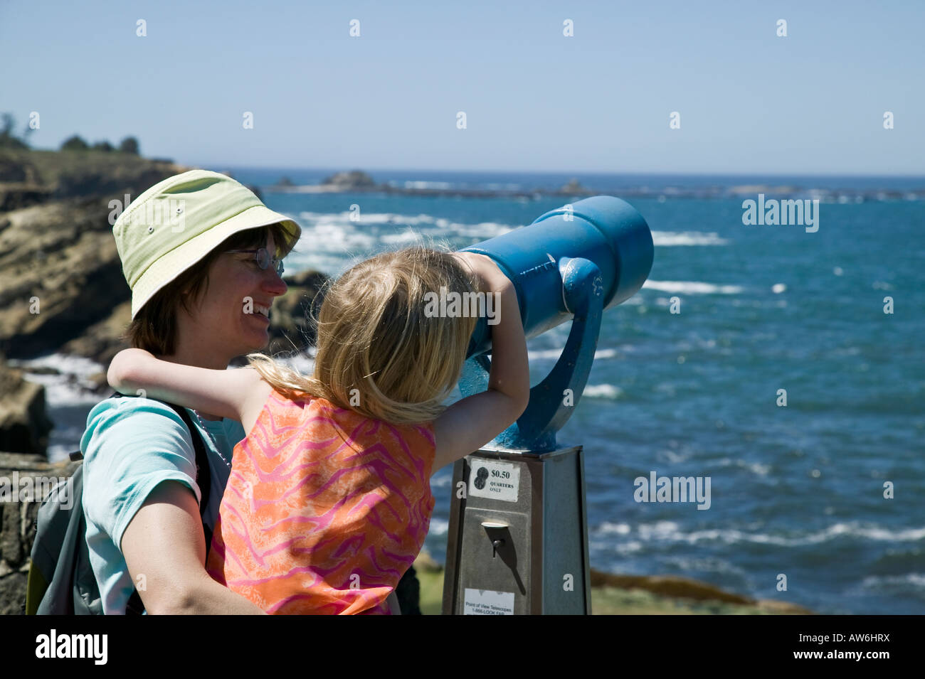 Mom and daughter and viewing scope Shore Acres State Park, Oregon, USA