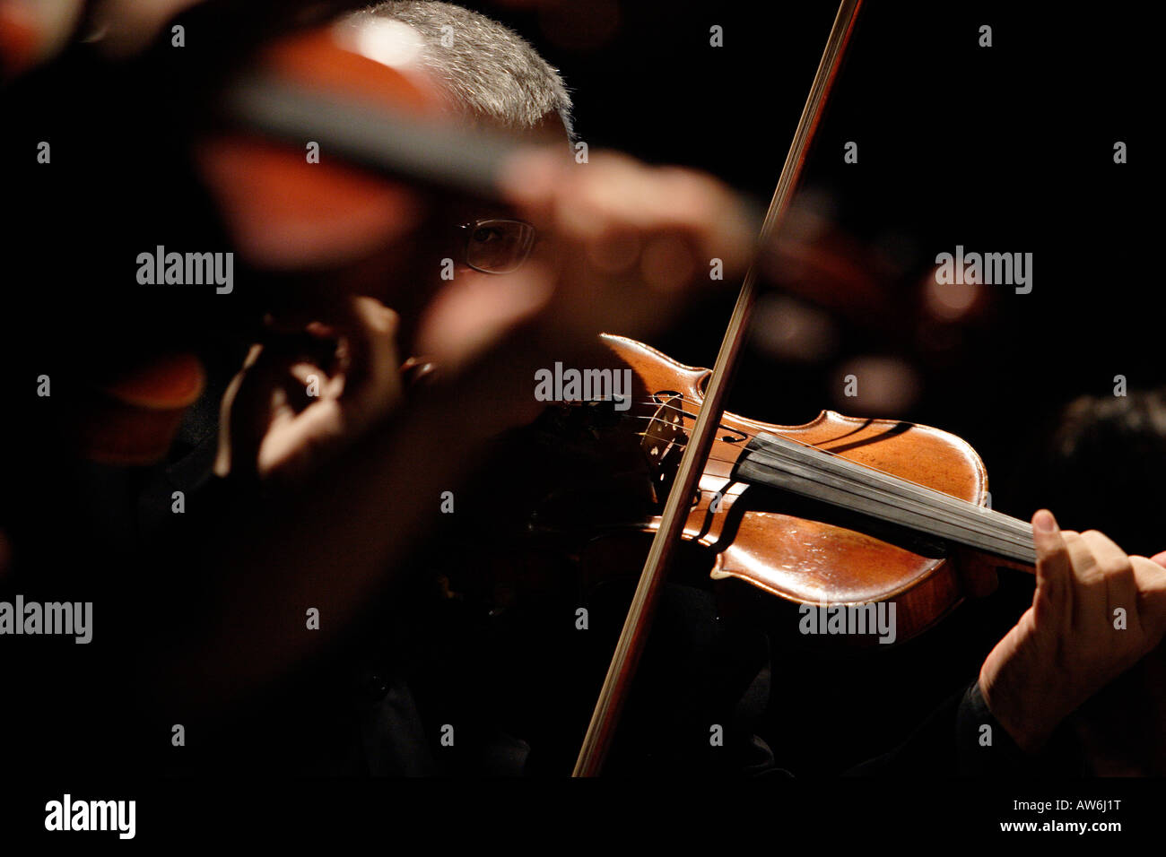 VIolinist playing in a orchestra Stock Photo