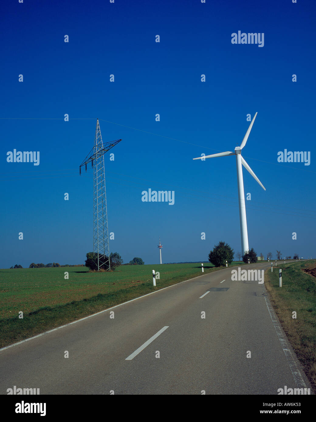 road, windmill and  power line at the end of the road , Bavaria, Germany. Photo by Willy Matheisl Stock Photo