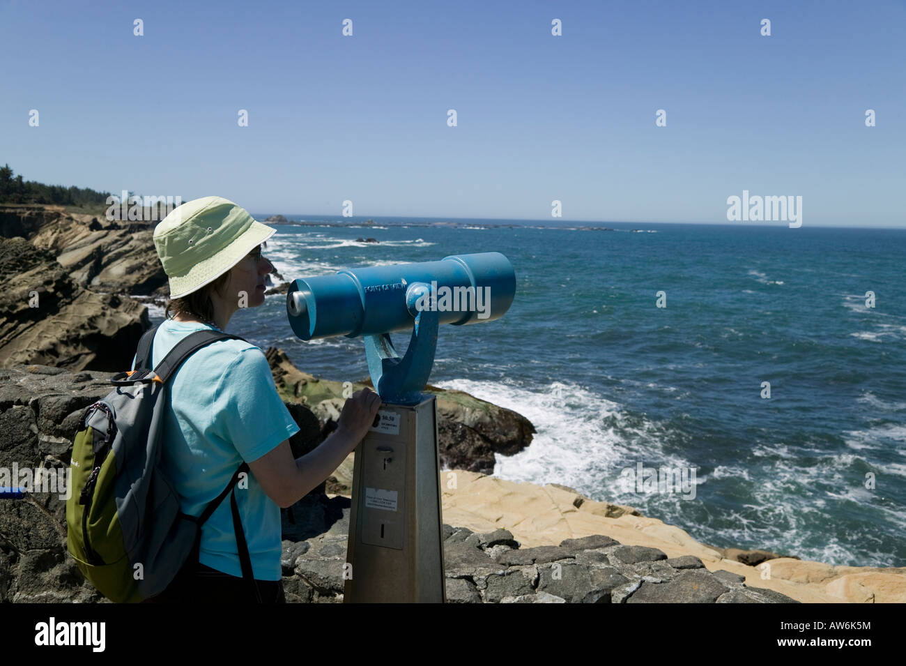 Woman and viewing scope Shore Acres State Park, Oregon, USA Stock Photo