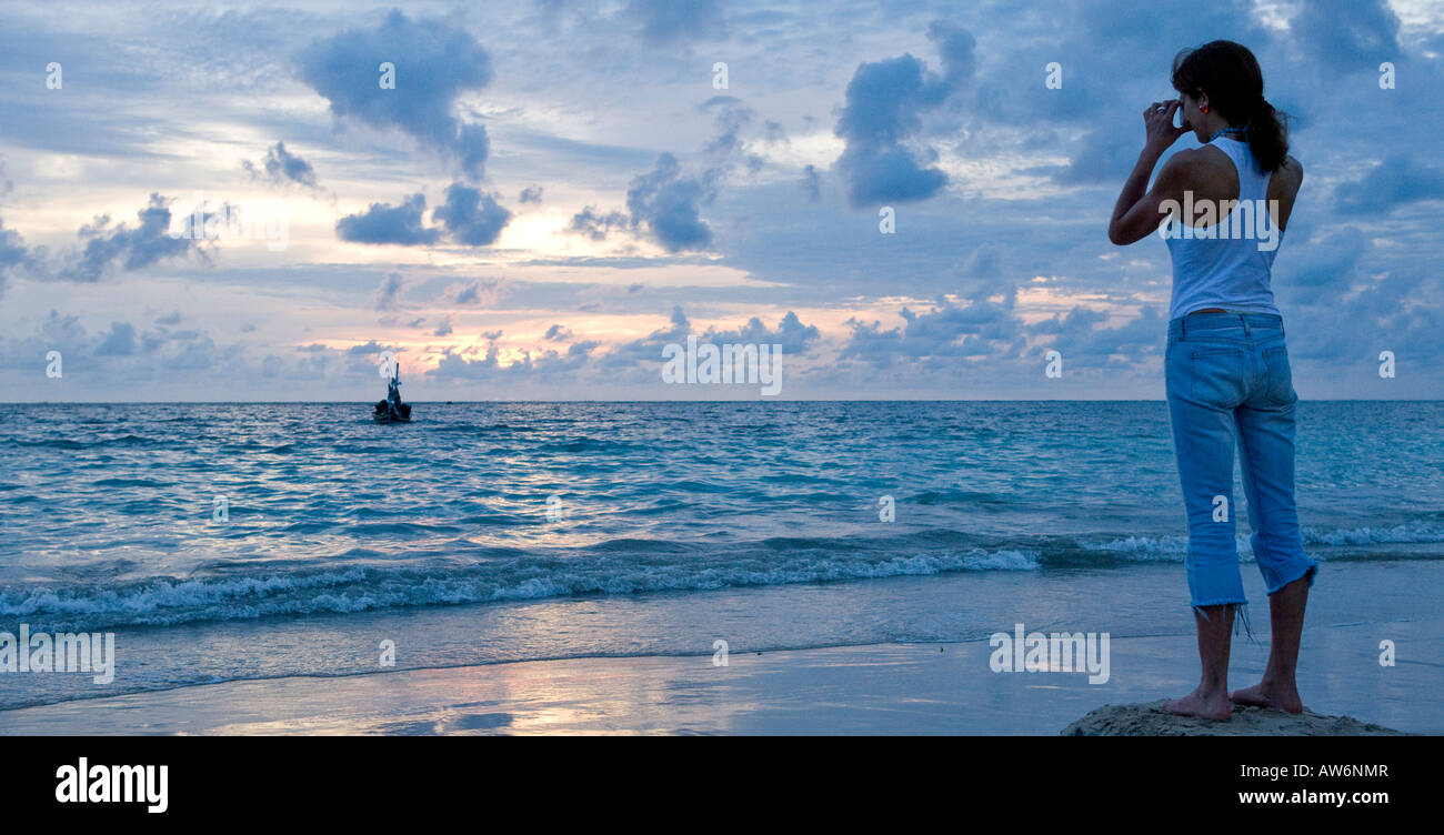 Woman alone watching sunset hi-res stock photography and images - Alamy