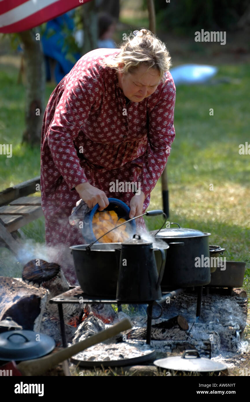 https://c8.alamy.com/comp/AW6NYT/woman-cooking-in-cast-iron-pots-over-an-open-fire-AW6NYT.jpg