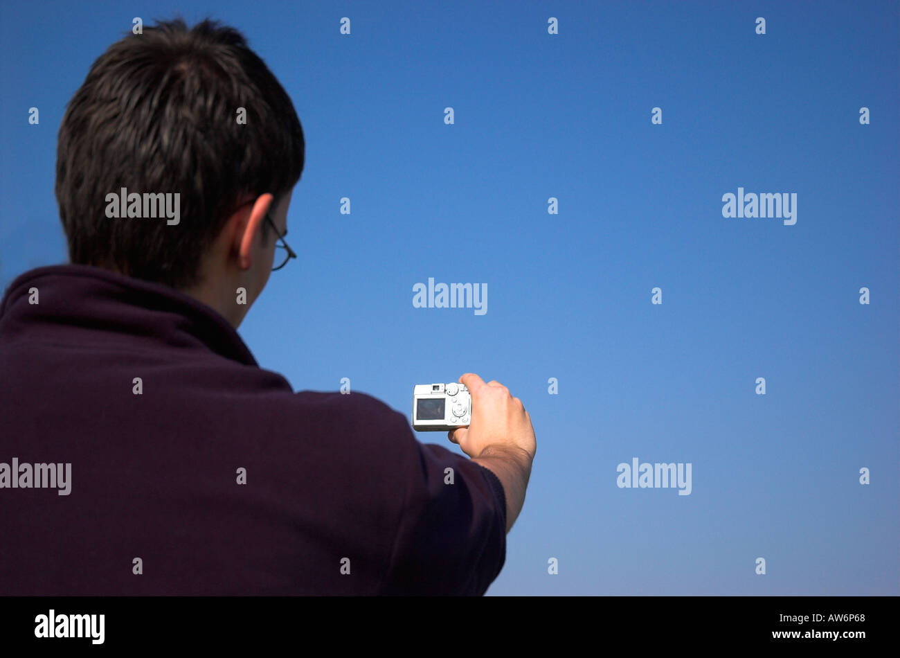 Young man holding digital camera Stock Photo