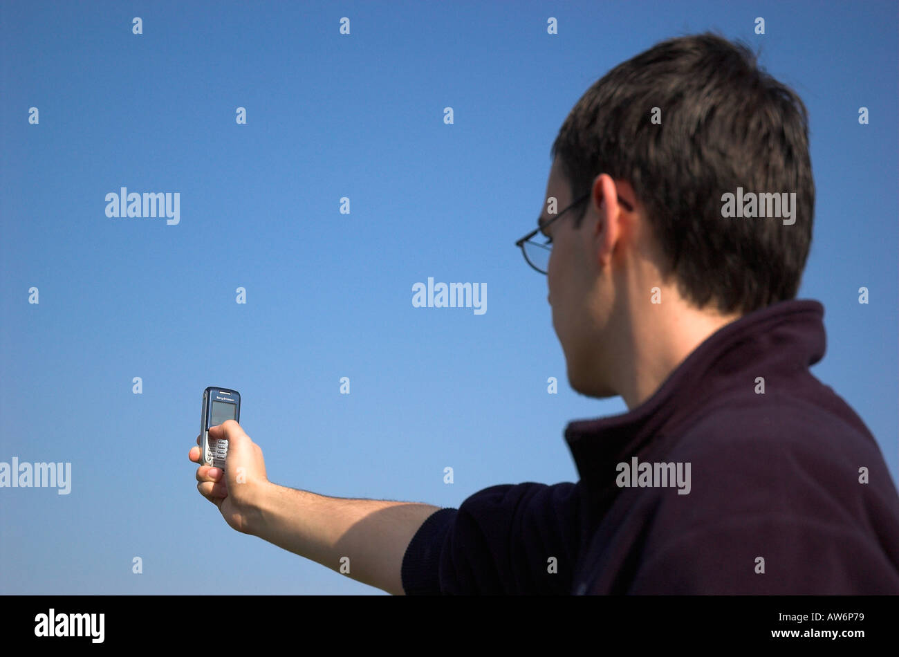Young man using camera phone Stock Photo
