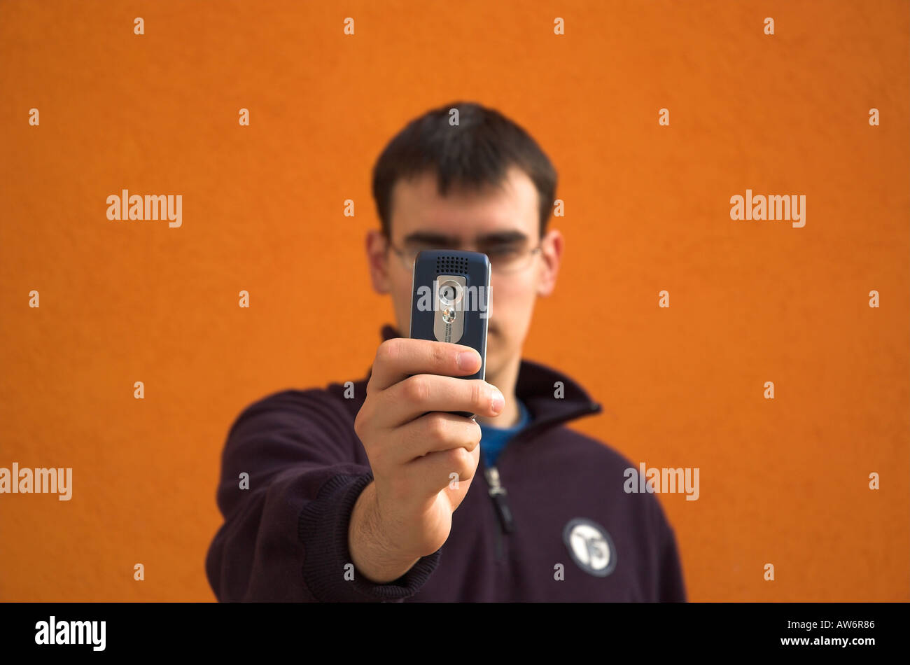 Young man using camera phone Stock Photo