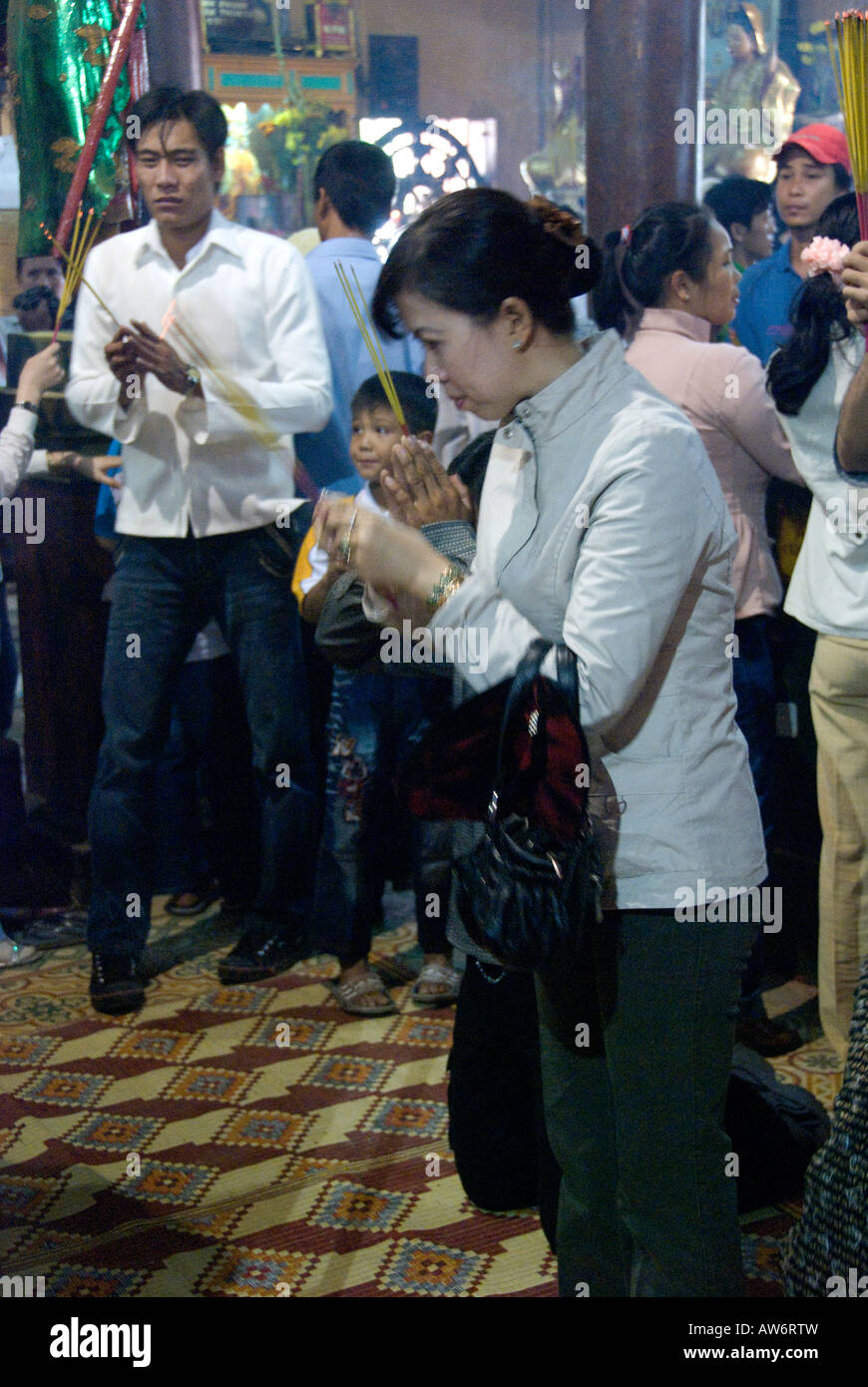 Pilgrims pray to Buddha inside the Tay An Pagoda, Nui Sam (Sam Mountain