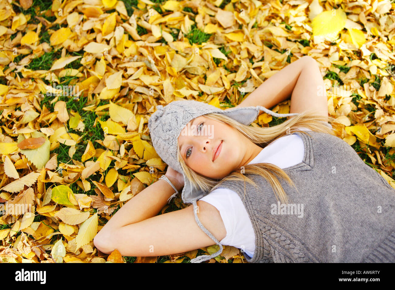 Young girl laying in the leaves Stock Photo - Alamy
