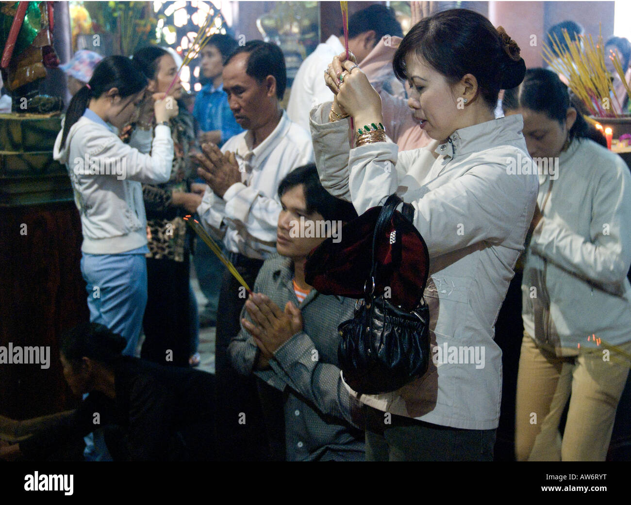 Pilgrims pray to Buddha inside the Tay An Pagoda, Nui Sam (Sam Mountain