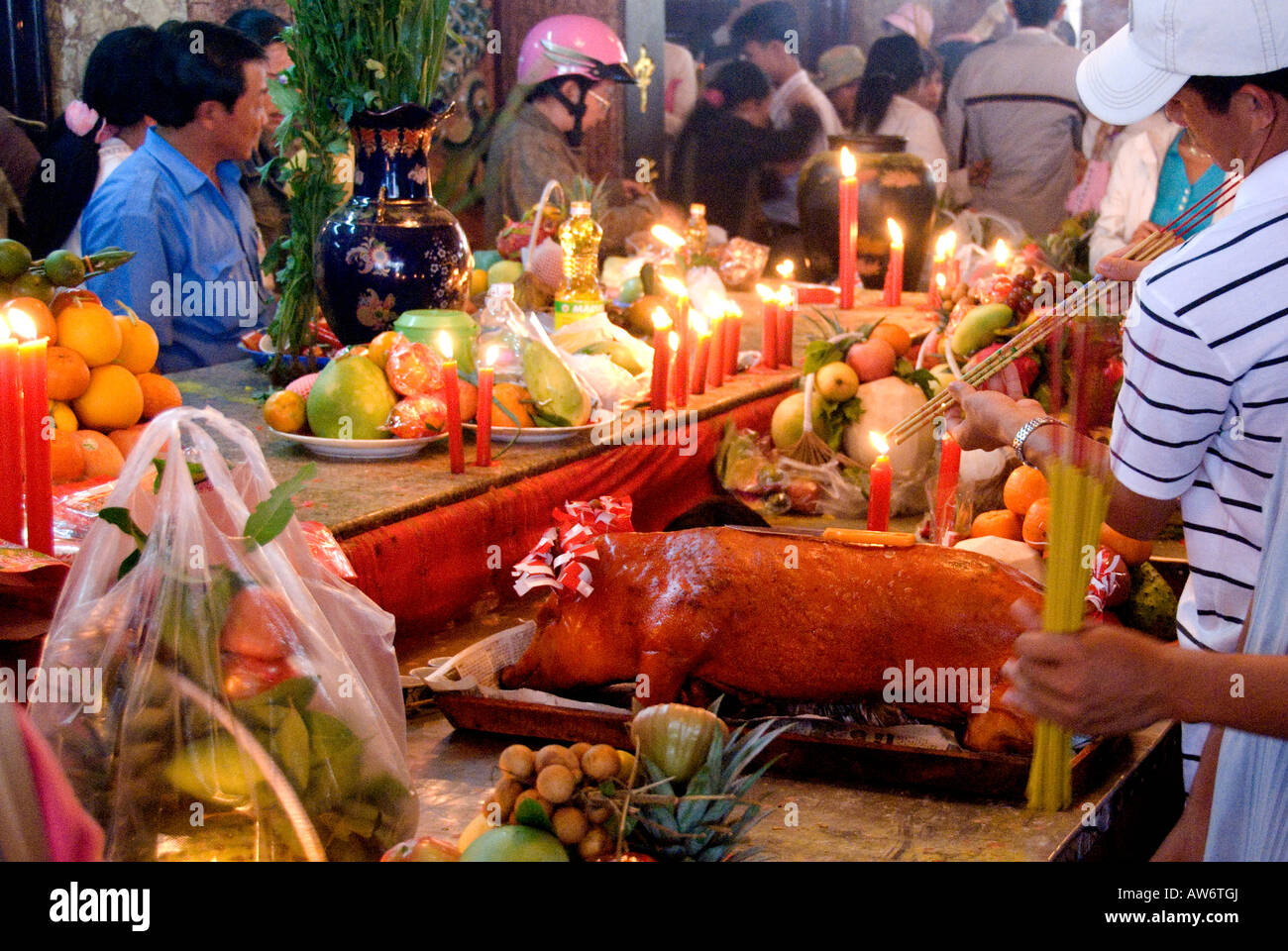 A pilgrim offers a roasted pig in the Temple of Lady Xu, Nui Sam during Tet, hoping for Good Luck and Prosperity in the New Year Stock Photo